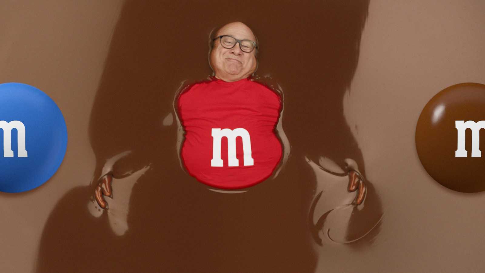 Danny DeVito swims in chocolate in this bizarre M&M's Super Bowl ad