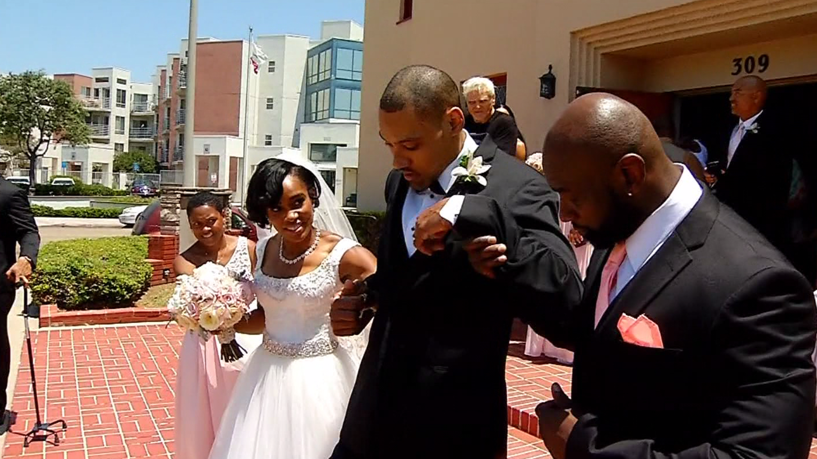 Step by halting step, Olympian walks down aisle with his wife