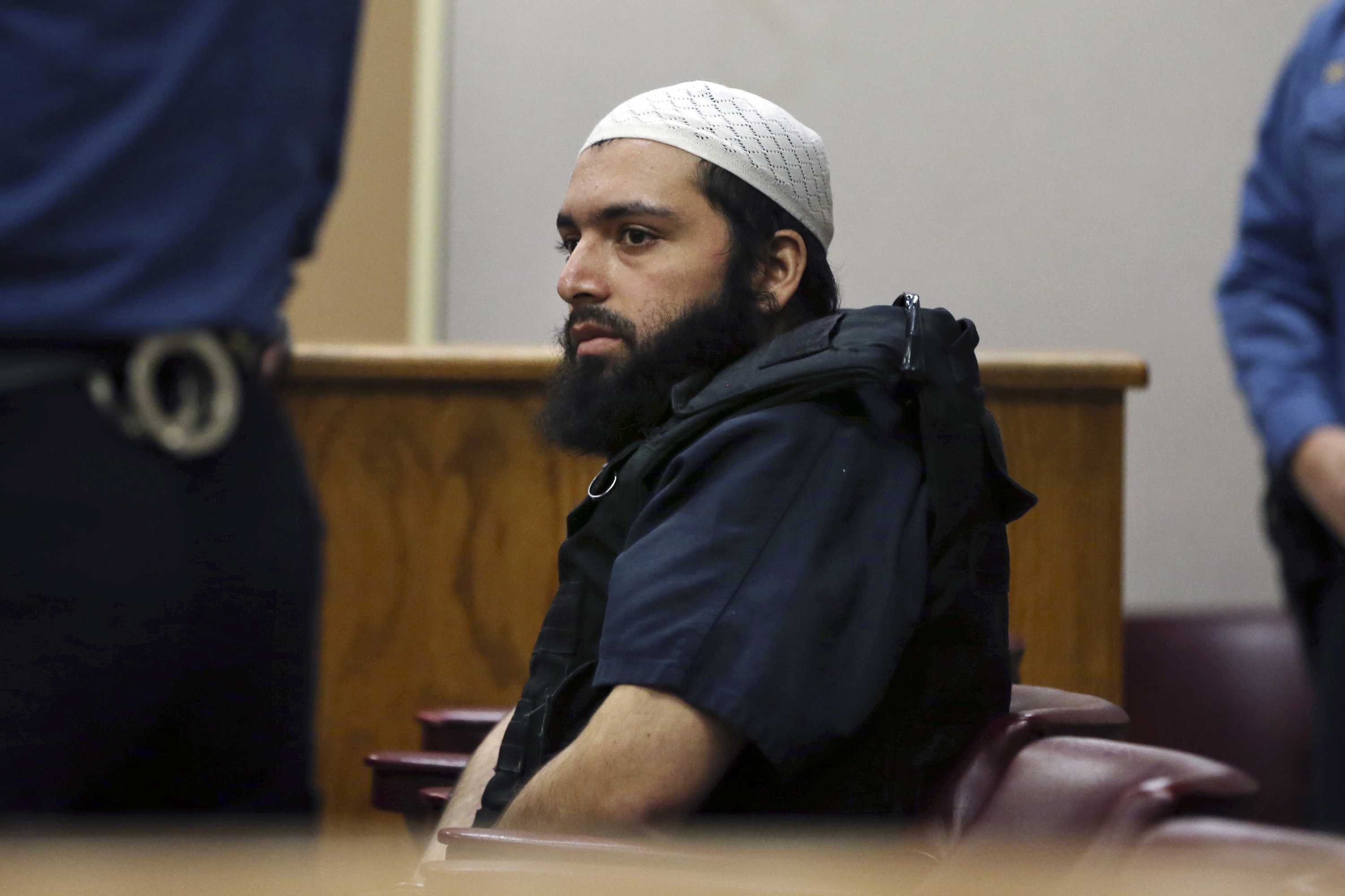 Ahmad Khan Rahimi the man accused of setting off bombs in New Jersey and New York's Chelsea neighborhood in September sits in court in Elizabeth N.J. Prosecutors are urging a judge to impose a life sentence on Rah