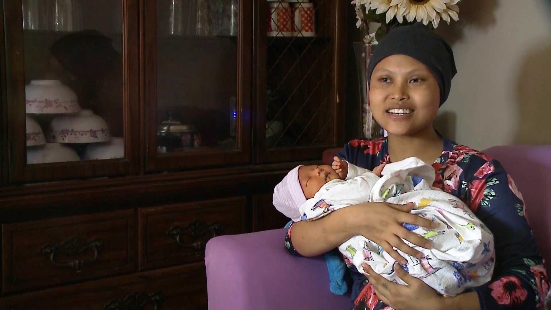 Woman delivers baby on hospital lawn