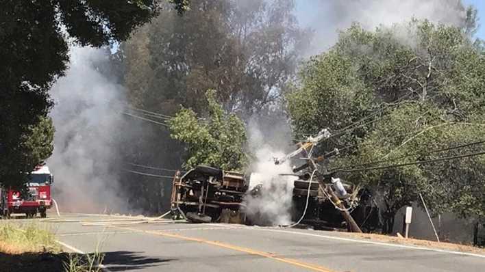 Big rig crashes into power pole, overturns, starts vegetation fire