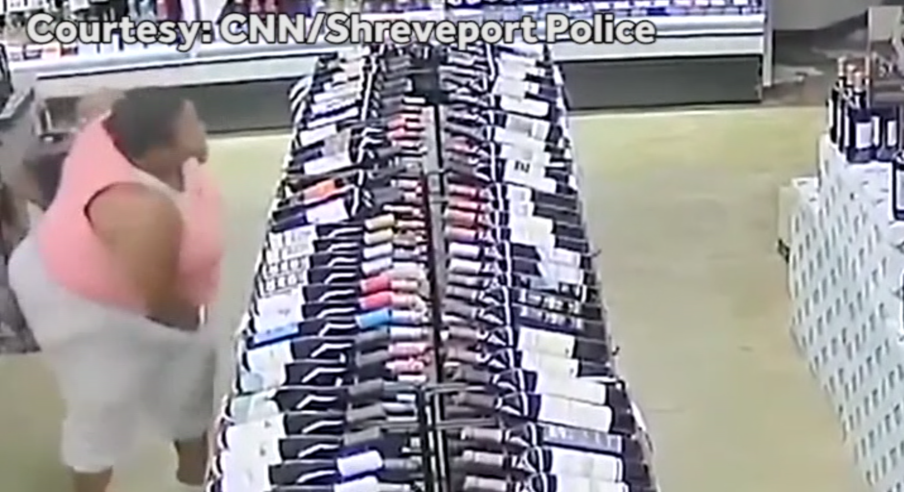 CAUGHT ON CAMERA: Woman stuffs 17 bottles of alcohol under clothes