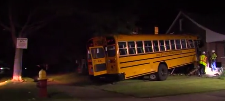 School bus crashes into home