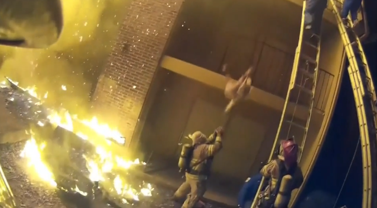 Incredible video: Firefighter catches child dropped from burning building