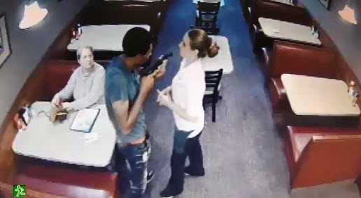 Caught on camera: Robber holds gun inches away from employee's face