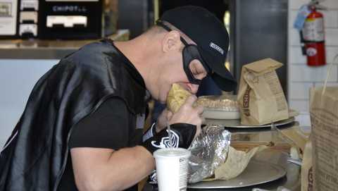 Bruce Wayne of Tiffin, Ohio enjoys his 426th consecutive Chipotle meal. To celebrate, Chipotle presented Wayne with his own Chipotle-inspired superhero gear, complete with a cape and mask. 