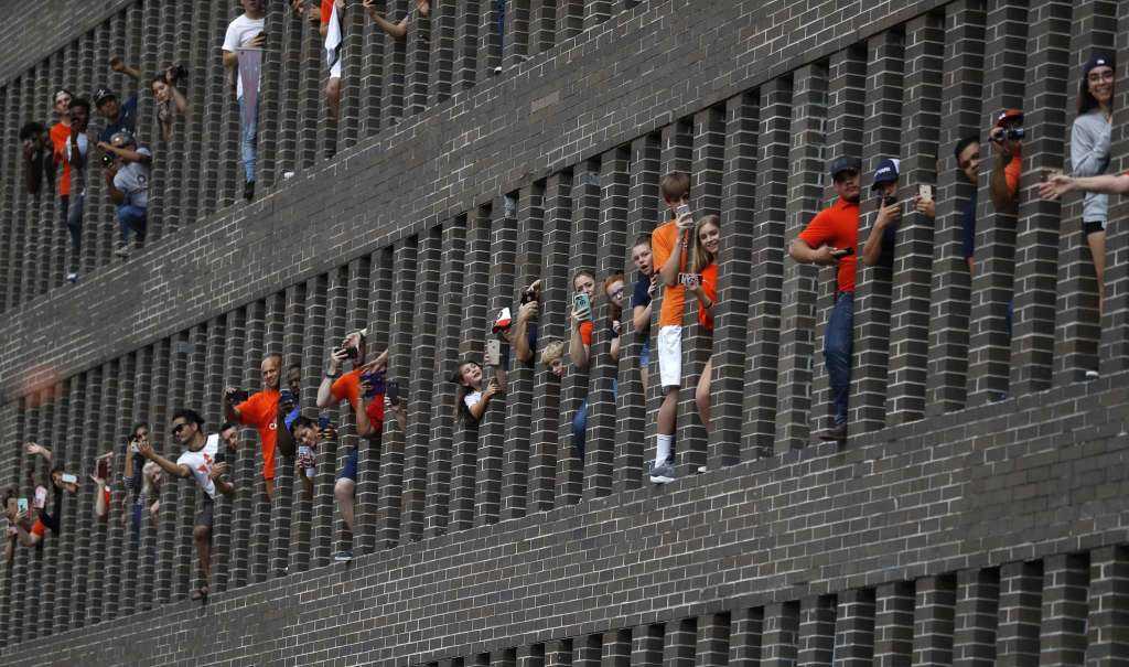 Reveling Astros fans use teamwork to save a cap that fell 7 stories