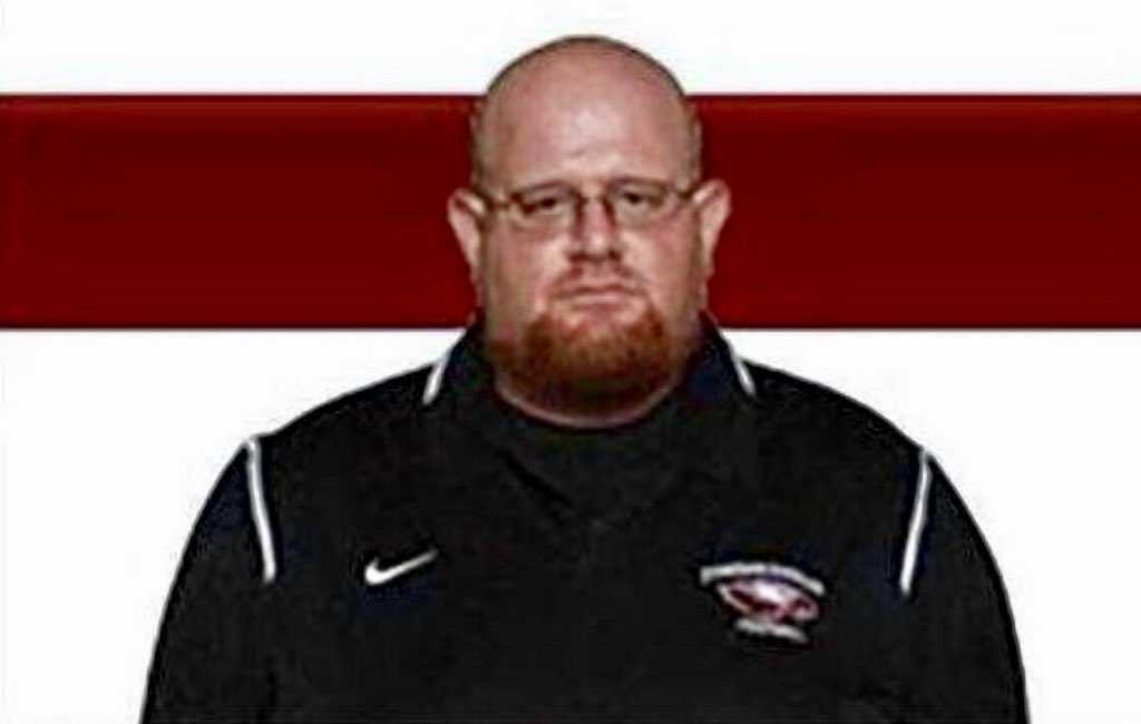 Football coach who 'selflessly shielded students from shooter' dies