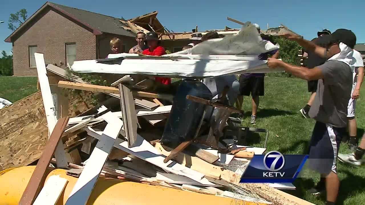 Football team trades working out for helping out after tornado