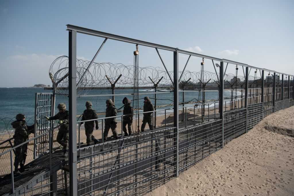 Surfers catching waves near the Korean Demilitarized Zone
