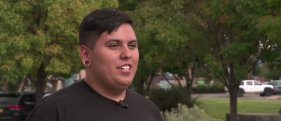 Student helps woman push car off busy street during rainstorm