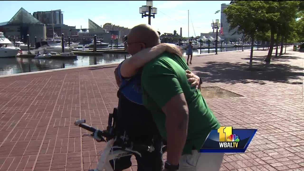 Man aims to cheer people up, one hug, high-five at a time
