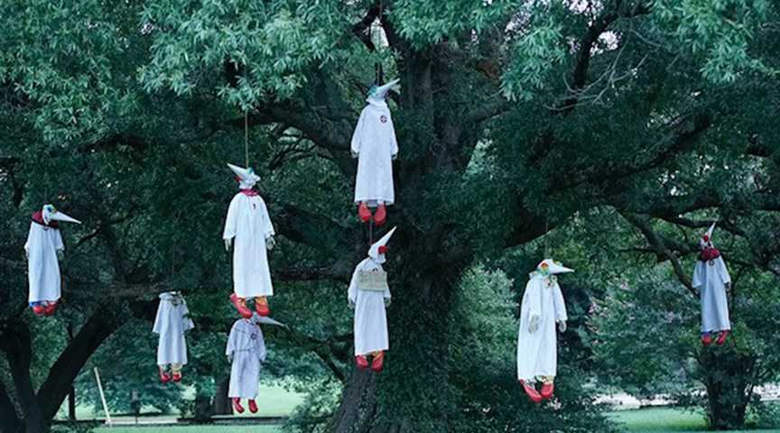 Clowns dressed in KKK robes hung from tree by activist group