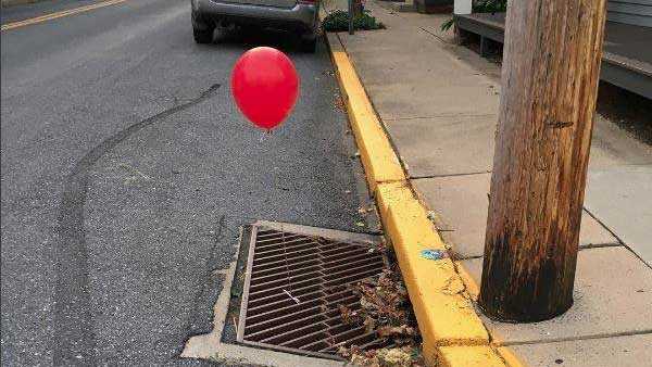 Police 'terrified' by red 'It' balloons tied to sewer grates