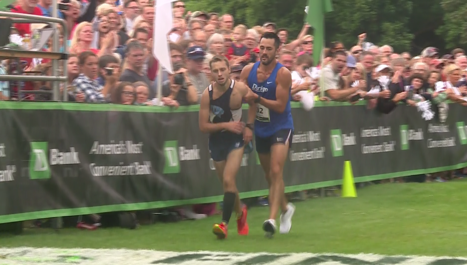 Incredible moment: Collapsing runner crosses finish line with competitor's help