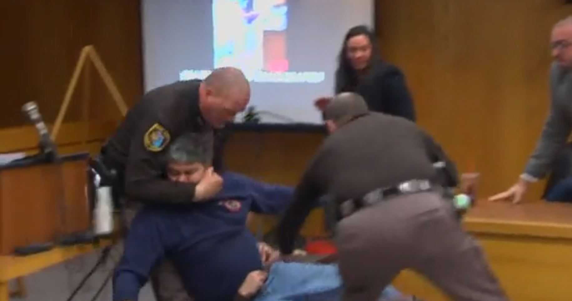 Victims' father apologizes after trying to attack Larry Nassar in court