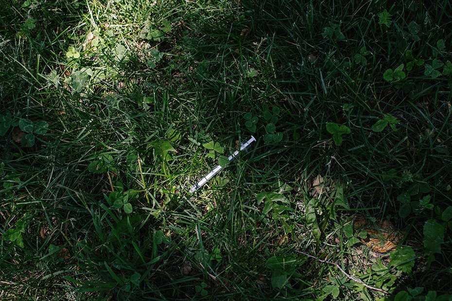 Student stabs children with syringe found on sidewalk, police say