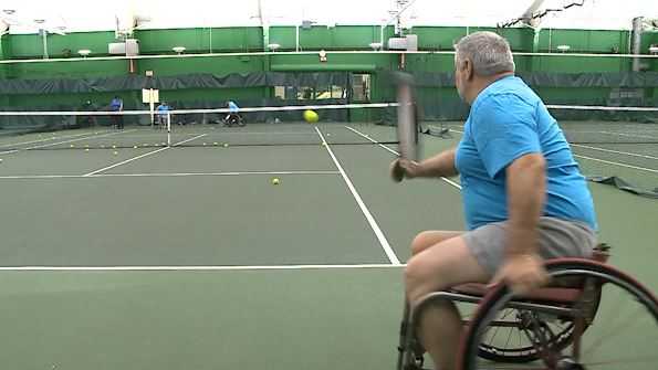 Athletes with disabilities play adaptive tennis