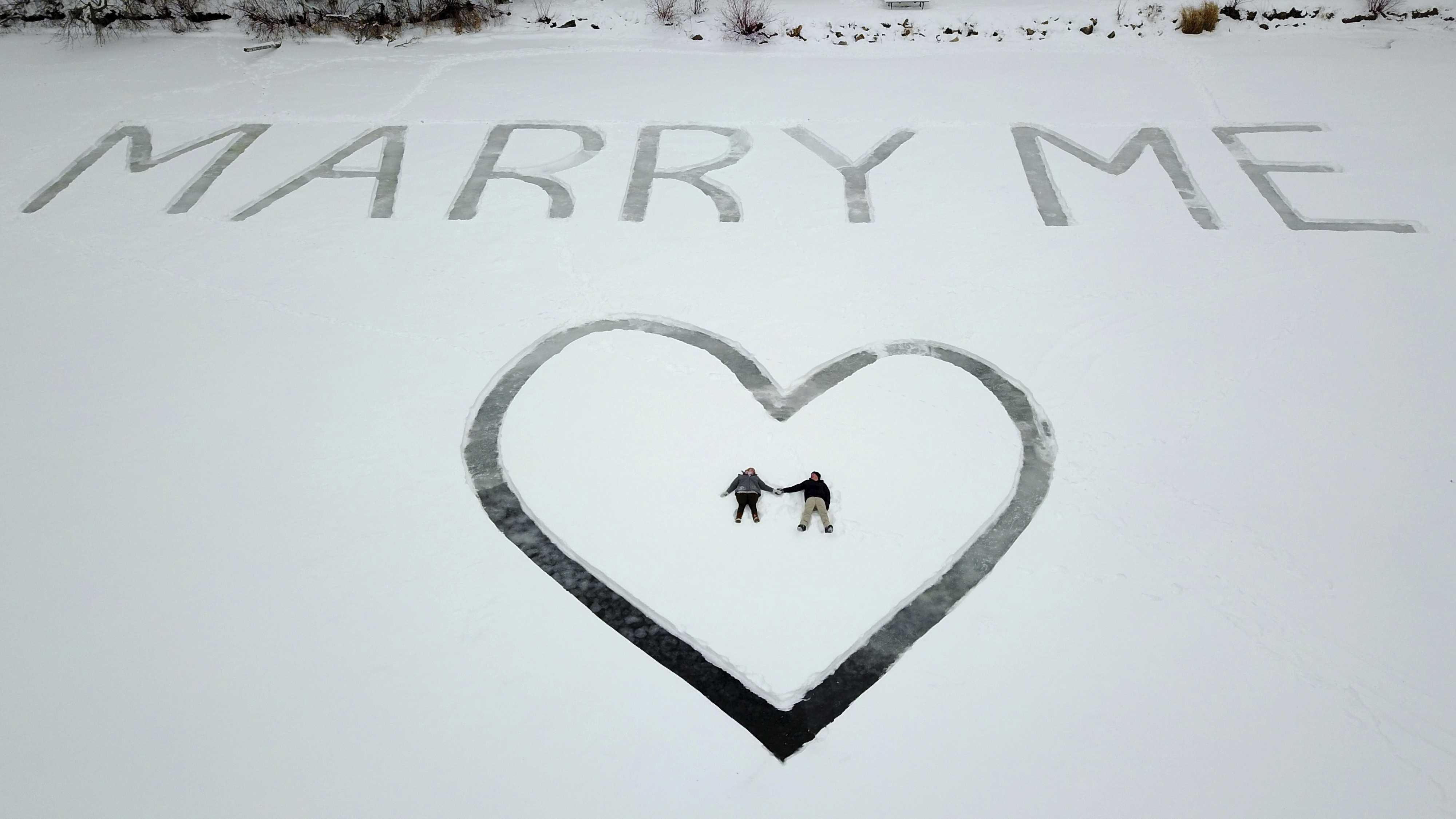 Pilot shows girlfriend marriage proposal etched in snow on frozen lake