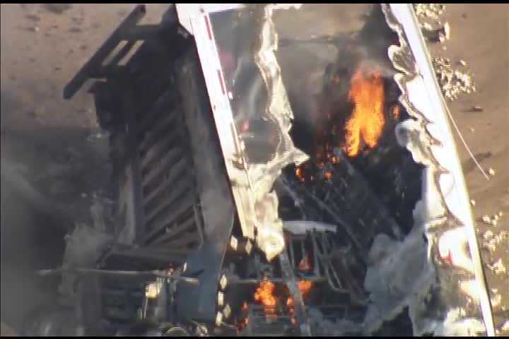 One killed after semi-truck falls off bridge, catches fire on H.E. Bailey Turnpike