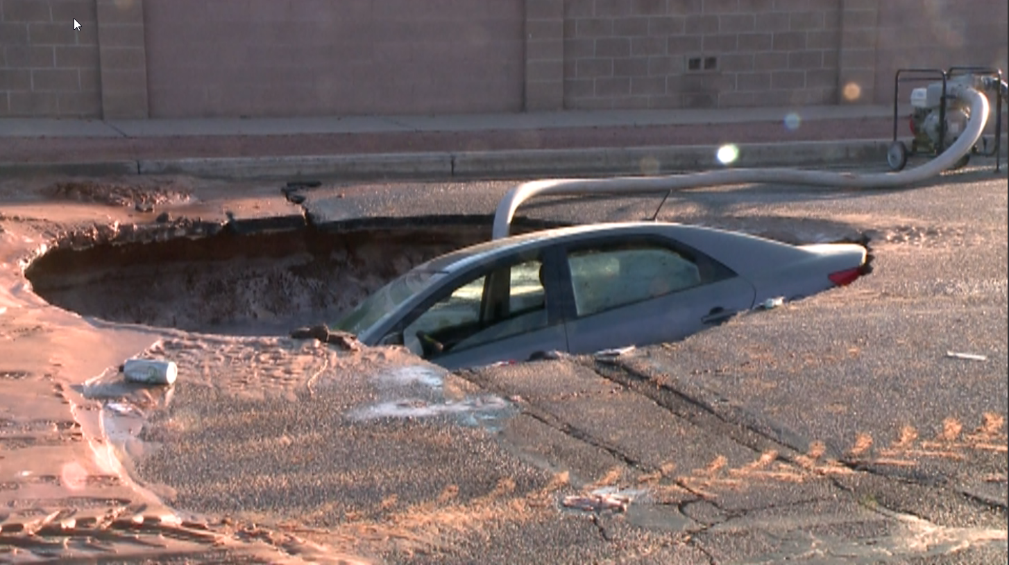 Vehicle gets trapped in massive sinkhole