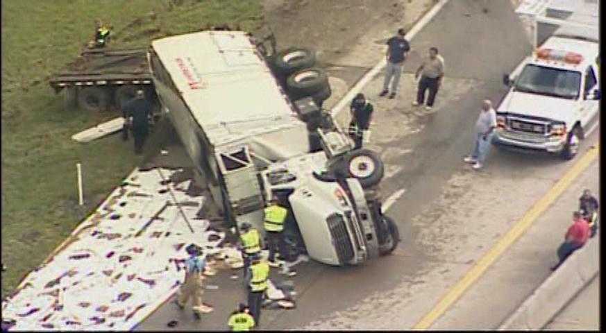 Truck overturns, closes highway