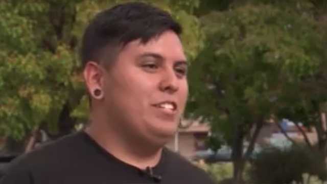 Student helps woman push car off busy street during rainstorm