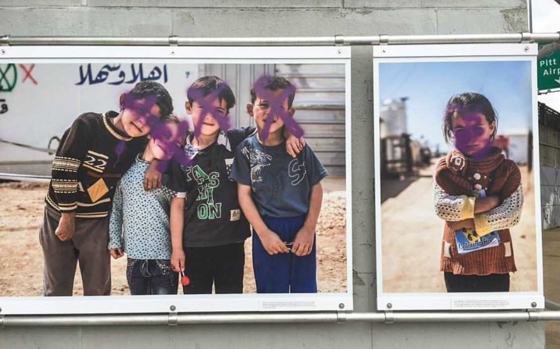 Photos of Syrian refugees defaced at Pittsburgh art festival