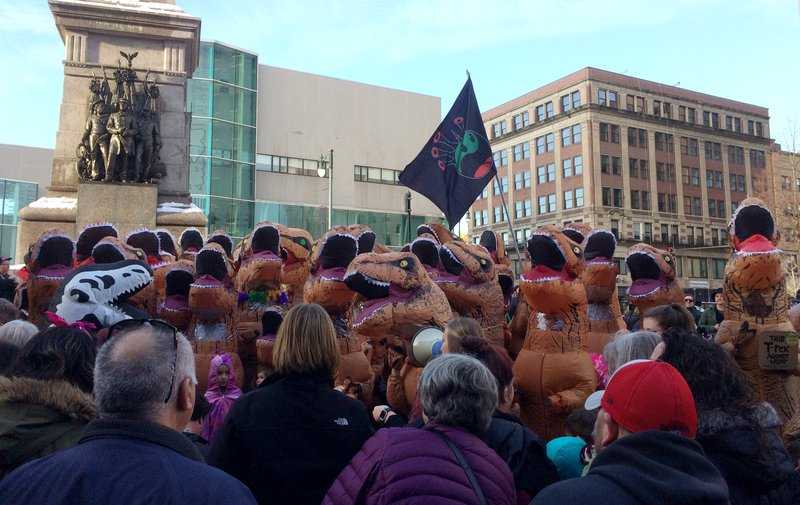 Dozens dressed as Tyrannosaurus rex descend on public square