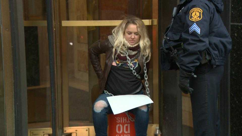 Women chain themselves to Downtown Pittsburgh building, home of Sen. Pat Toomey's office, to protest tax bill