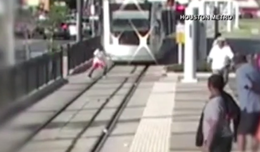 Video captures life-threatening close call of boy crossing train track