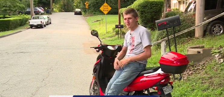 Photo of man hauling giant couch on tiny scooter goes viral