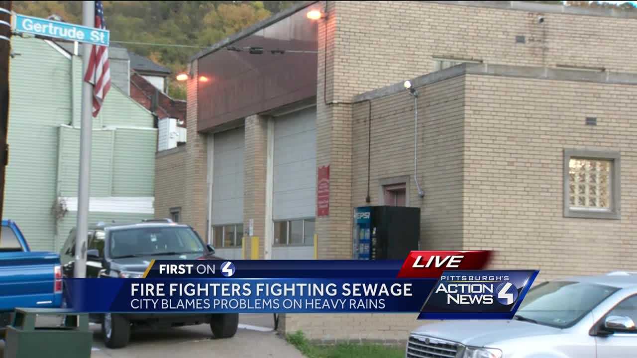 Fire fighters fighting sewage after weekend storms