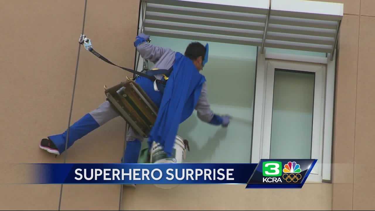Window washers dress as super heroes to cheer up sick kids