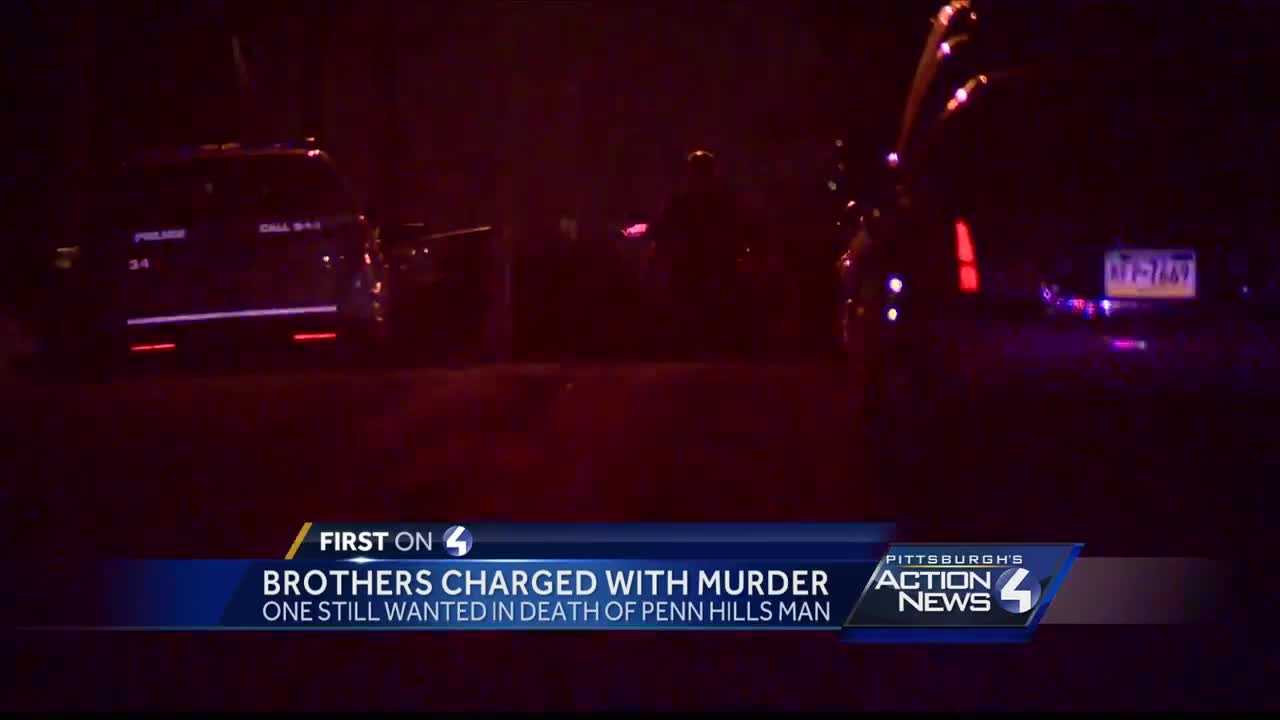 Brothers charged with murder, one still on the run