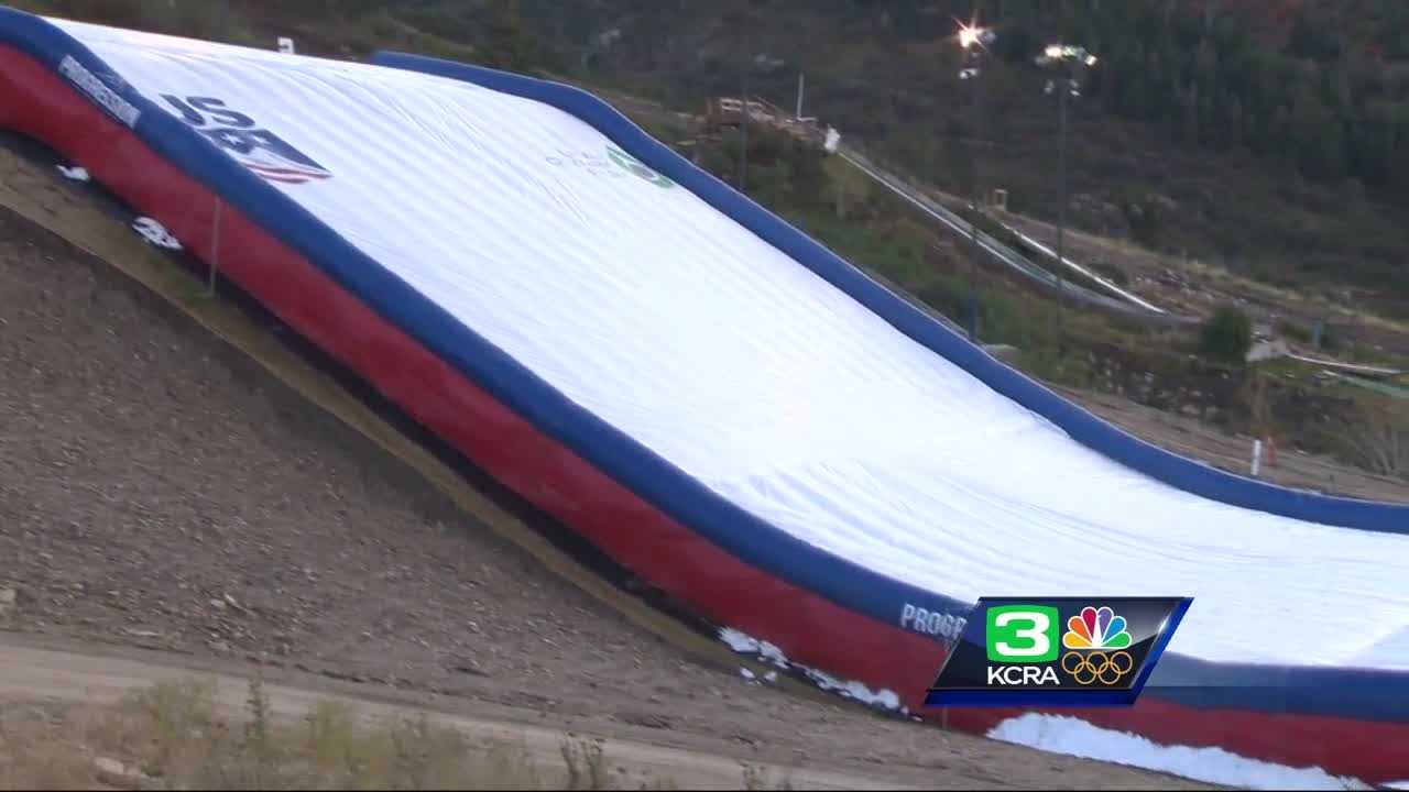 Olympic snowboarders practice on giant airbag